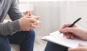 man sits and participates in EMDR therapy