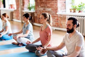 group participates in yoga therapy 