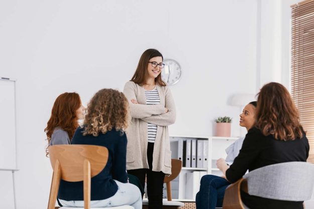 woman standing in a group during womens recovery