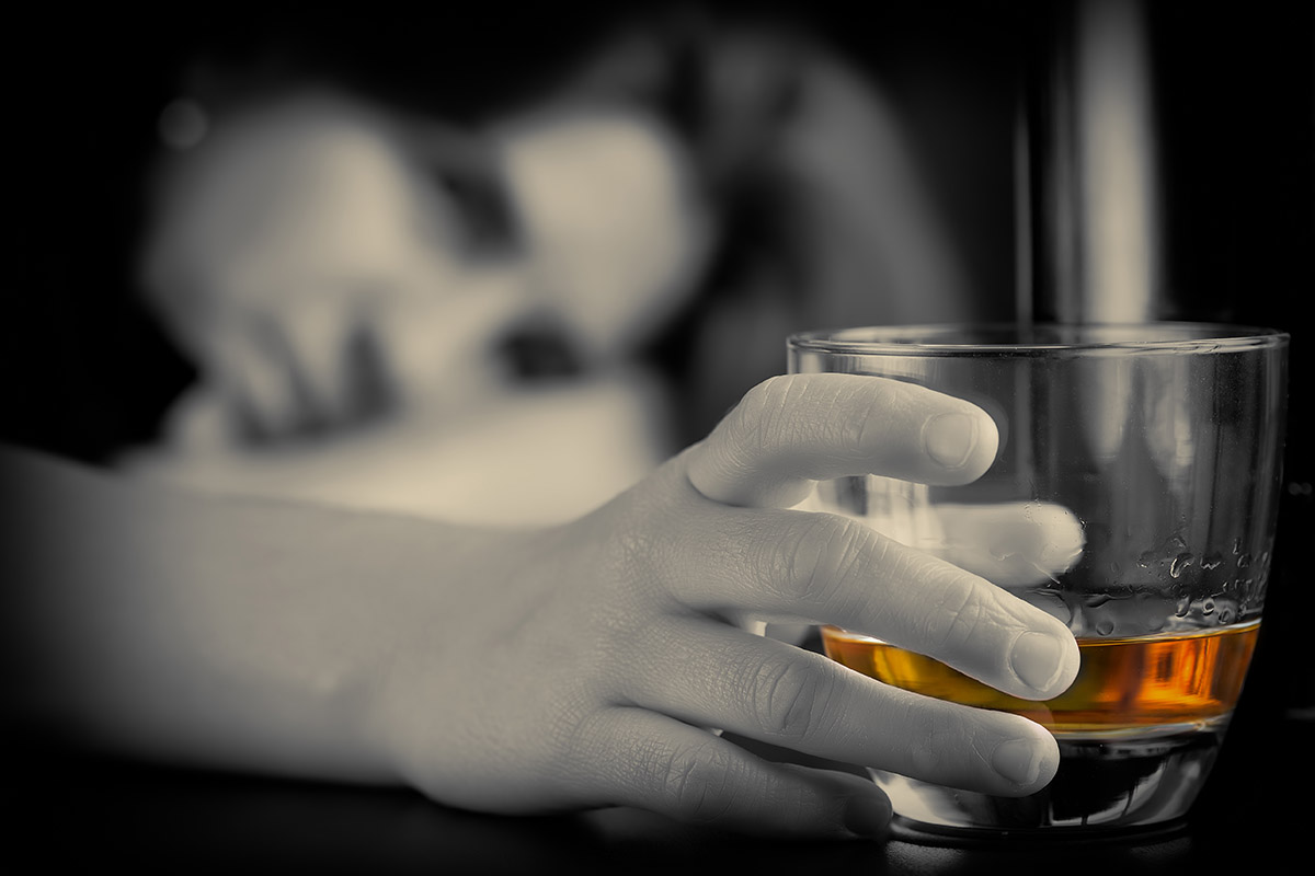 Alcohol Abuse and Mental Health person holding glass of alcohol and learning about alcohol abuse and mental health