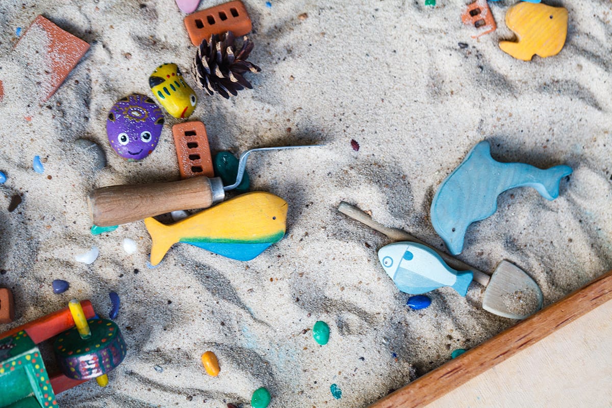 Are There Different Types Of Play Therapy Sand box full of toys, one of the different types of play therapy