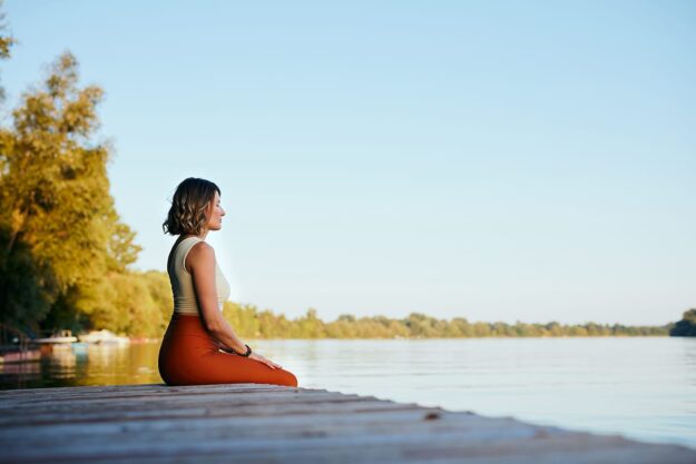Why Does Alcohol Cause Female Hormonal Imbalance Woman sits on dock and ponders if alcohol causes hormonal imbalance