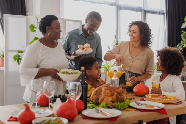 5 Tips for Setting Healthy Boundaries With Family This Thanksgiving Relatives laugh and bond after setting healthy boundaries with family for Thanksgiving