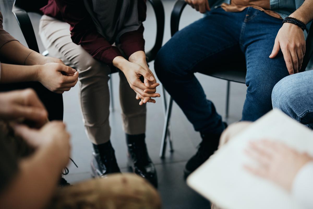 Is Group Therapy Right for me Person sits in group and wonders, "is group therapy the right option?"