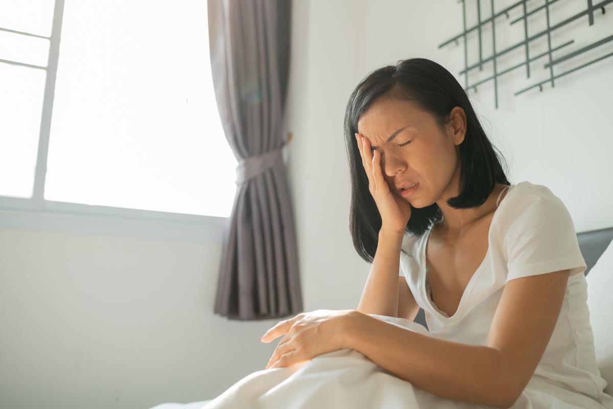 Woman puts face in hand as she wonders if she has developed bulimic teeth