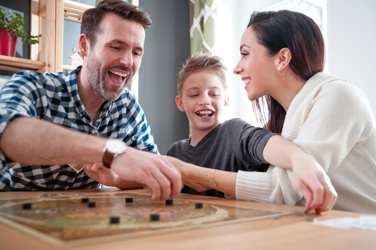 20 Family Therapy Games and Activities to Strengthen Bonds Family laughs and bonds while engaging in family therapy games