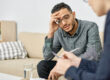 Man listens as therapist talks to him about transfer addictions