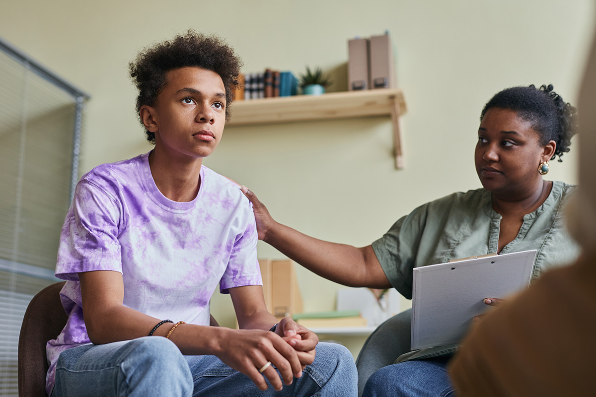 What Does A Partial Hospitalization Program Look Like For Teens Therapist and mom console teen as they discuss partial hospitalization program for teens